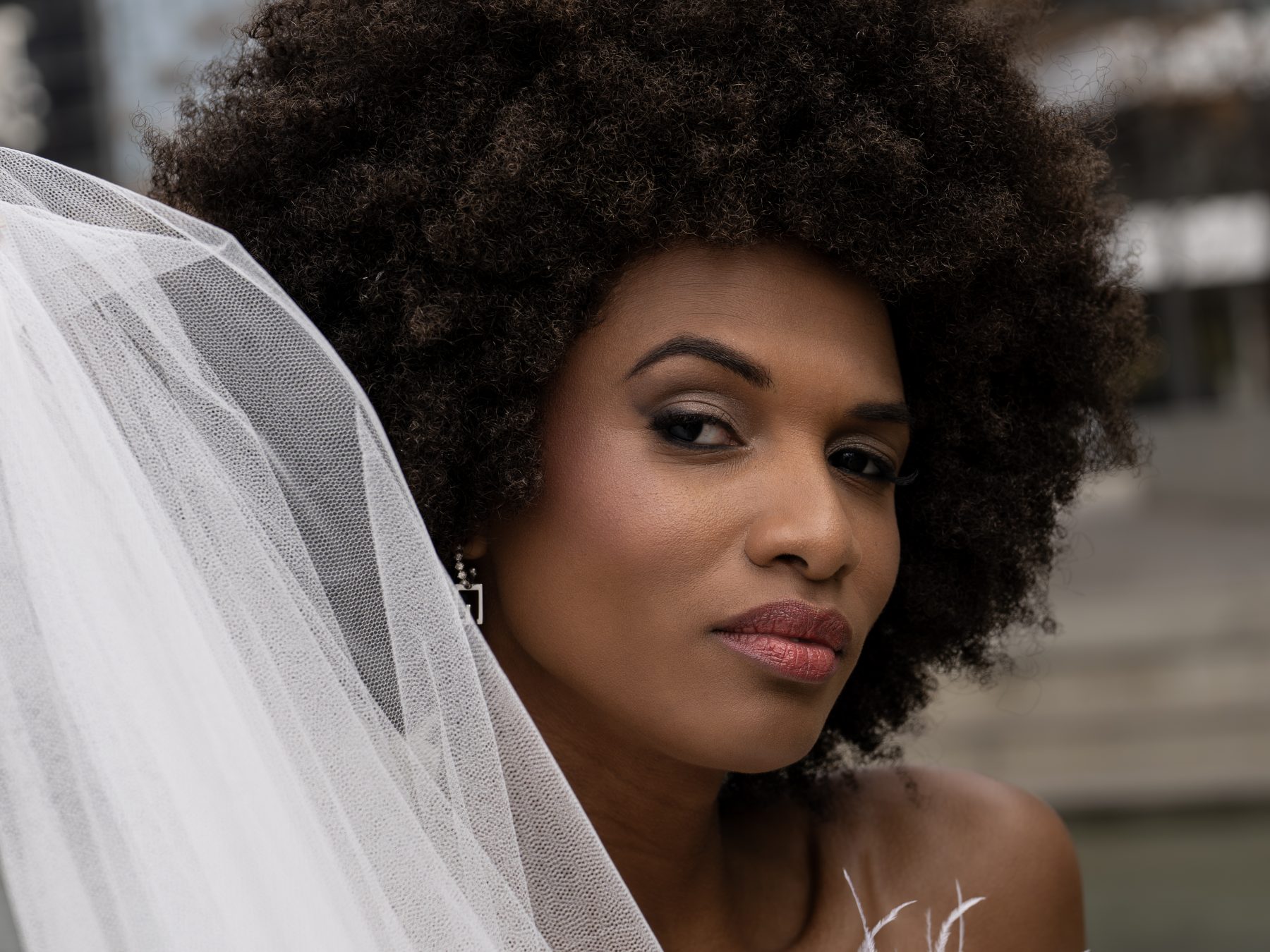 Close-up of a model with a white veil and intense gaze – editorial fashion photography by VicmanArt.